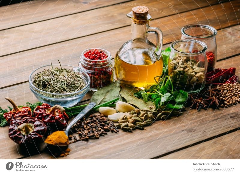 Spices and oil on table Herbs and spices Oil Table assortment Cooking Ingredients Set Fresh Dill Parsley Garlic anise turmeric Cardamom Coriander Chili