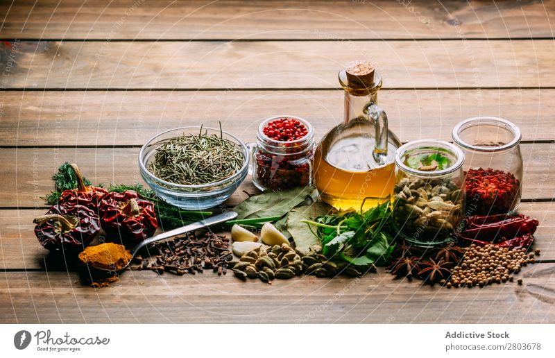 Spices and oil on table Herbs and spices Oil Table assortment Cooking Ingredients Set Fresh Dill Parsley Garlic anise turmeric Cardamom Coriander Chili