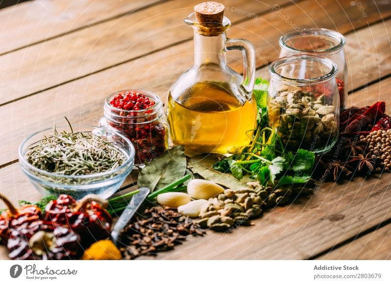 Spices and oil on table Herbs and spices Oil Table assortment Cooking Ingredients Set Fresh Dill Parsley Garlic anise turmeric Cardamom Coriander Chili