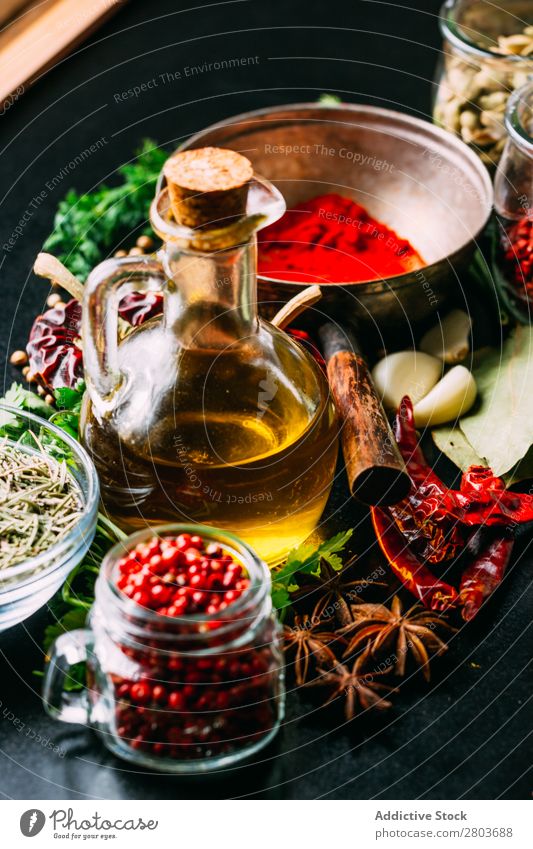 Spices and oil on table Herbs and spices Oil Table assortment Cooking Ingredients Set Fresh Dill Parsley Garlic anise turmeric Cardamom Coriander Chili