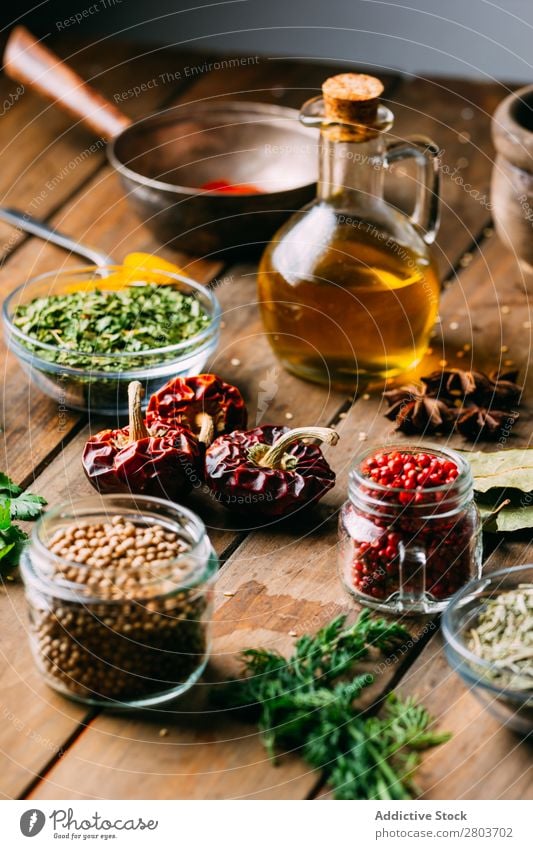 Spices and oil on table Herbs and spices Oil Table assortment Cooking Ingredients Set Fresh Dill Parsley Garlic anise turmeric Cardamom Coriander Chili