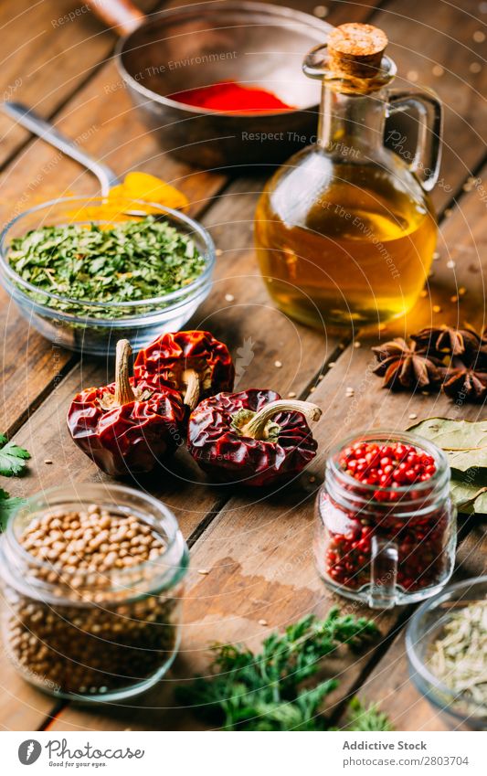 Spices and oil on table Herbs and spices Oil Table assortment Cooking Ingredients Set Fresh Dill Parsley Garlic anise turmeric Cardamom Coriander Chili