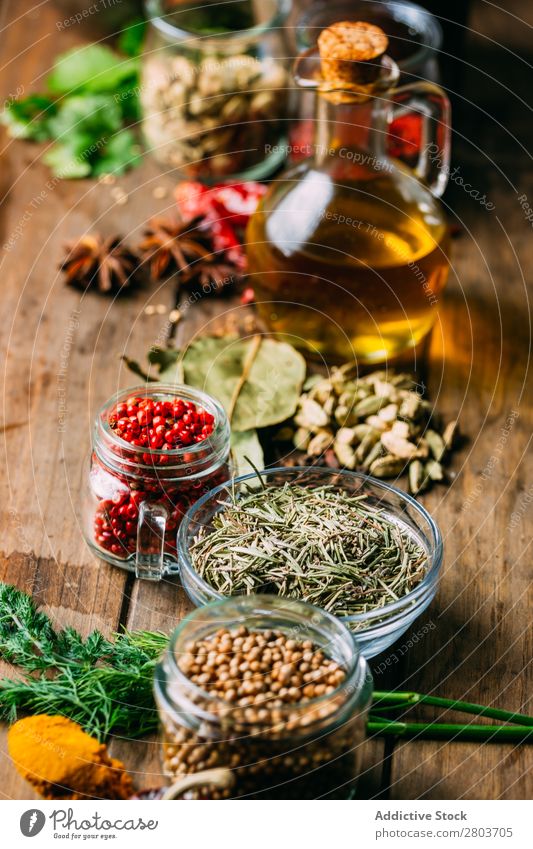 Spices and oil on table Herbs and spices Oil Table assortment Cooking Ingredients Set Fresh Dill Parsley Garlic anise turmeric Cardamom Coriander Chili