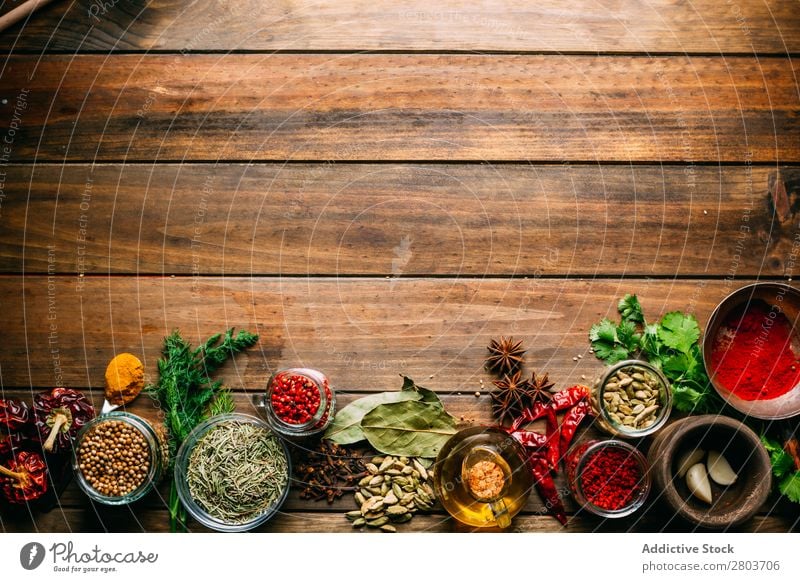 Spices and oil on table Herbs and spices Oil Table assortment Cooking Ingredients Set Fresh Dill Parsley Garlic anise turmeric Cardamom Coriander Chili