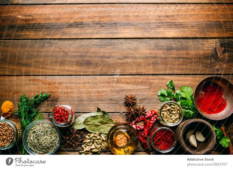 Spices and oil on table Herbs and spices Oil Table assortment Cooking Ingredients Set Fresh Dill Parsley Garlic anise turmeric Cardamom Coriander Chili