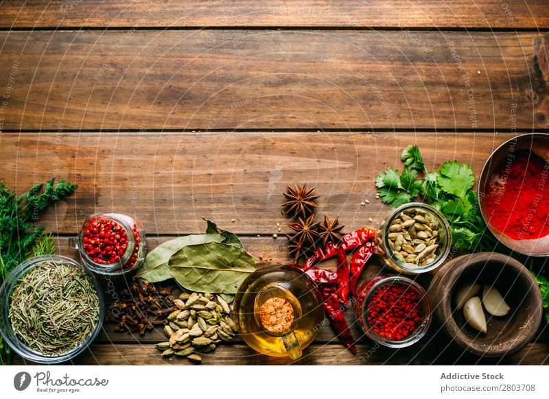 Spices and oil on table Herbs and spices Oil Table assortment Cooking Ingredients Set Fresh Dill Parsley Garlic anise turmeric Cardamom Coriander Chili