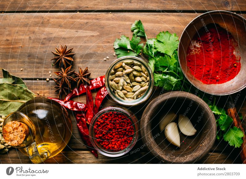 Spices and oil on table Herbs and spices Oil Table assortment Cooking Ingredients Set Fresh Dill Parsley Garlic anise turmeric Cardamom Coriander Chili