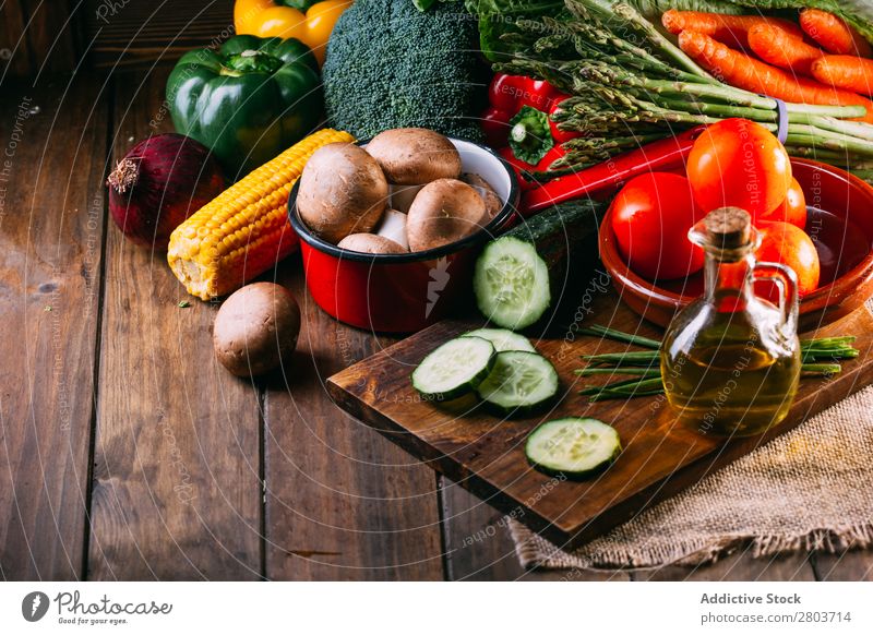 Vegetables and utensils on kitchen table Fresh Vitamin flat lay Oil composition Vertical corn Onion Ingredients Knives Pepper Bird's-eye view Food Cucumber Diet