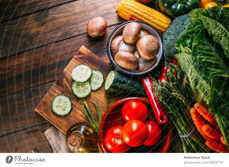 Vegetables and utensils on kitchen table Fresh Vitamin flat lay Oil composition Vertical corn Onion Ingredients Knives Pepper Bird's-eye view Food Cucumber Diet