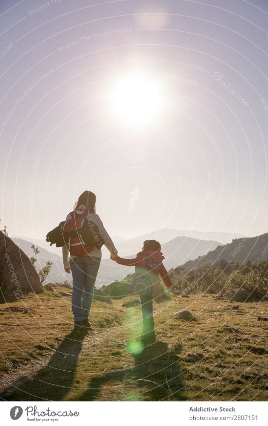 Mom keeps daughter's hand and walks on the nature in sunset light Mother Sunset Daughter Nature Girl Child Family & Relations Together Walking Love Joy