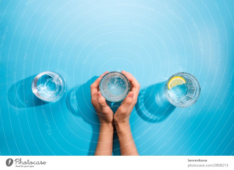 Woman's hands holding a cup of clean sparkling water Fresh Clean Bottle Object photography Beverage Cold Summer Cup Mug jar Difference Glass Caucasian White