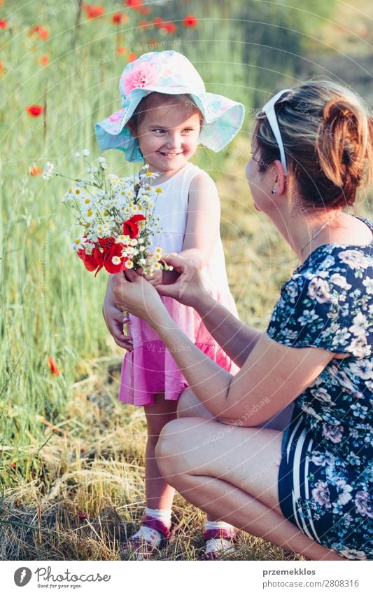 Mother and her little daughter in the field of wild flowers Lifestyle Joy Happy Beautiful Summer Garden Child Human being Woman Adults Parents