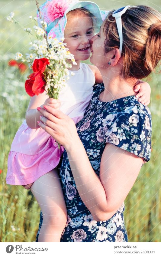 Mother and her little daughter in the field of wild flowers Lifestyle Joy Happy Beautiful Summer Garden Child Human being Woman Adults Parents