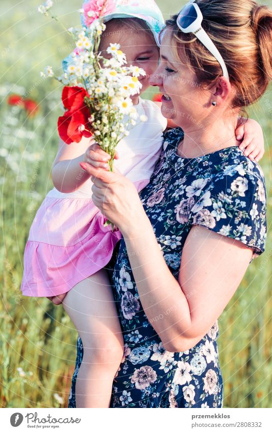 Mother and her little daughter in the field of wild flowers Lifestyle Joy Happy Beautiful Summer Garden Child Human being Woman Adults Parents