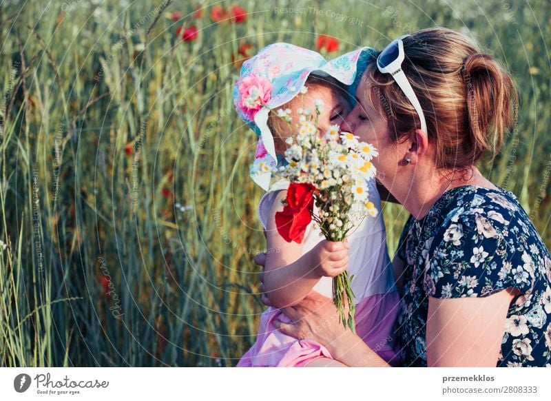 Mother and her little daughter in the field of wild flowers Lifestyle Joy Happy Beautiful Summer Garden Child Human being Woman Adults Parents