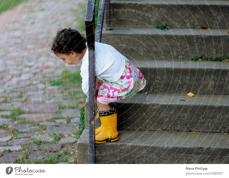 being insouciant Playing Child Human being Feminine Girl Infancy Body 1 1 - 3 years Toddler Stairs Cobblestones Handrail Rubber boots Black-haired Movement