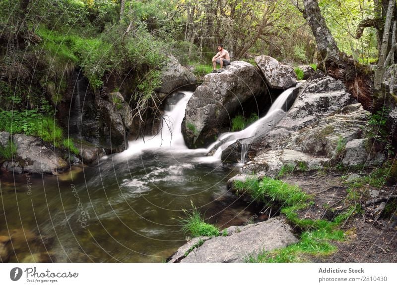 Young man enjoys rest at the waterfall Water Nature Summer Vacation & Travel Man enjoying Waterfall Healthy Body Conceptual design Green Fresh handsome