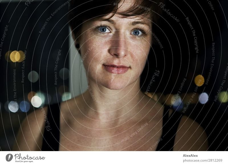 Portrait of a young woman with freckles Elegant Joy Beautiful Well-being Room Window City light Young woman Youth (Young adults) Adults Face Freckles