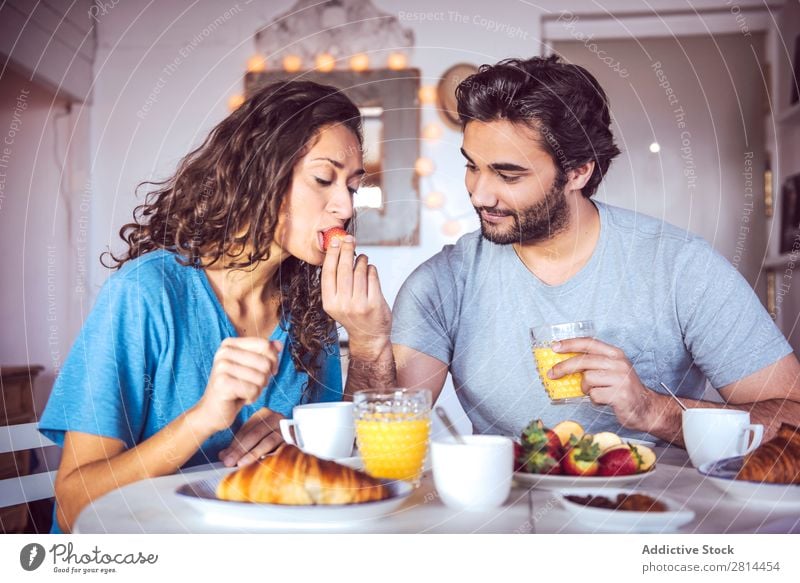 Happy couple having breakfast together Home Youth (Young adults) Grapefruit 2 Breakfast Man Easygoing Human being Life Woman Adults Girl Husband dining Bread