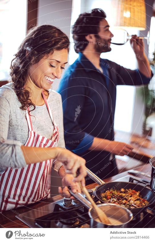 Young couple cooking. Man and woman in their kitchen Cooking Kitchen Home Dinner Youth (Young adults) Eating Wife Adults Smiling Interior design Husband Salad