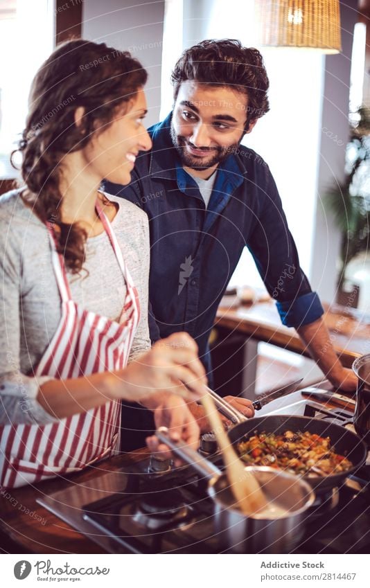 Young couple cooking. Man and woman in their kitchen Cooking Kitchen Home Dinner Youth (Young adults) Eating Wife Adults Smiling Interior design Husband Salad