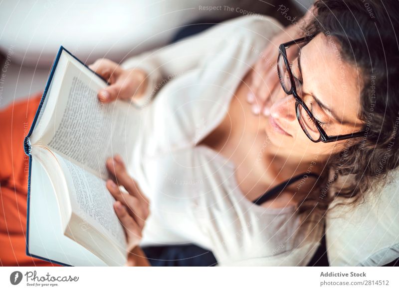 Young couple reading book on couch at home Book Home Literature Sofa Leisure and hobbies closeness Attractive Denim Vantage point Sit Day Life Adults fondness