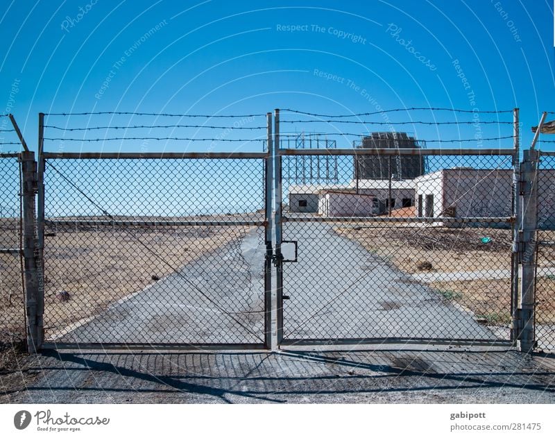 You're not going to get me in trouble. Information Technology Landscape Cloudless sky Summer Drought Crete Outskirts Deserted Industrial plant Ruin Gate