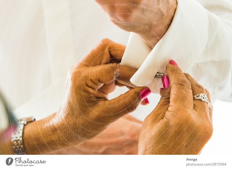 A groom putting on cuff-links in his wedding day. Luxury Elegant Style Wedding Office Business Human being Masculine Man Adults Hand Fingers Fashion Clothing