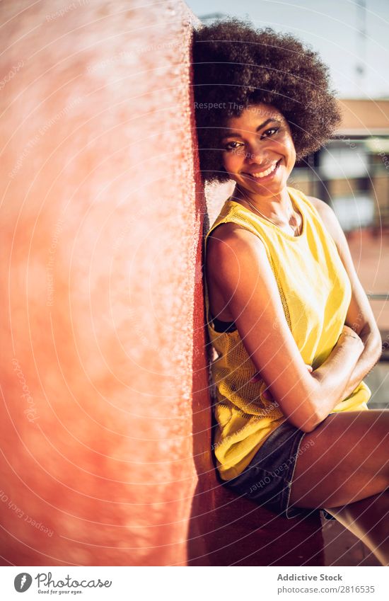 Beautiful African girl with curly hair on the rooftop Fashion Skin fashionable Clothing Street vogue Model Attractive copy Racing sports pose glamour Commercial