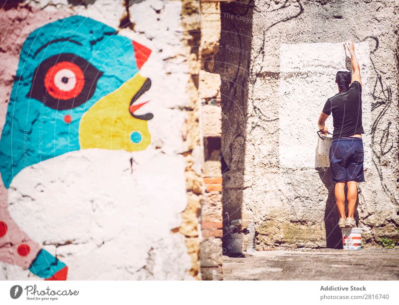 PALERMO, ITALY - JULY 17, 2016: Artist making a street art painting, on July 17, 2016 in Palermo, Sicily, Italy Ancient Architecture Vientiane City Europe