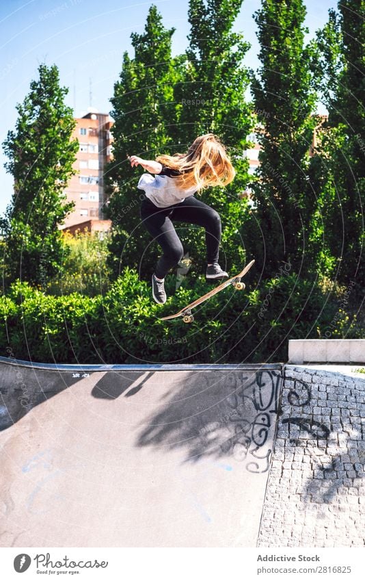 Skateboarding woman practicing at skatepark asian Action Exterior shot Sunlight Ramp Park committed ollie determined Movement Human being 1 Woman Energy