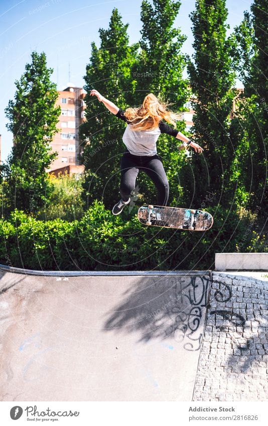 Skateboarding woman practicing at skatepark asian Action Exterior shot Sunlight Ramp Park committed ollie determined Movement Human being 1 Woman Energy