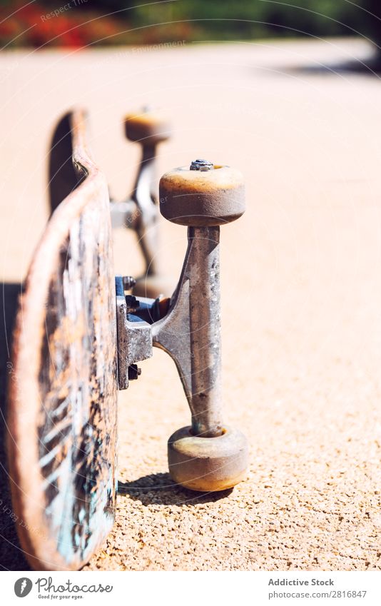 Old used skateboard over the ground Skateboard Skateboarding Wheels Retro Isolated Dirty Leisure and hobbies Joy Action Park Vantage point Horizontal Shot