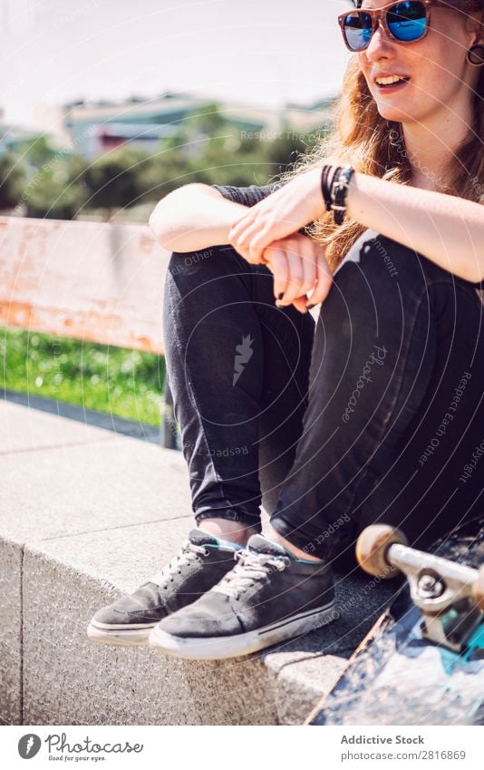 Woman skateboarder sitting in a park asian Skateboarding Sunglasses Joy Park Hat Chinese Music Town Culture Cap Exterior shot Sit Fitness 1 Black Hold Smiling