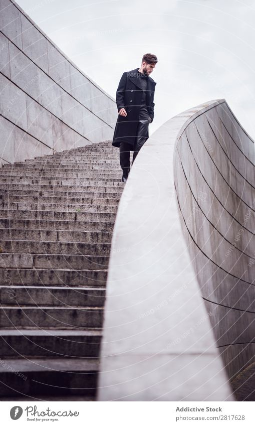 Young handsome trendy man with coat posing on stairs Adults Attractive Beard bearded Boy (child) Easygoing Caucasian Cool (slang) Cute Deep Expression