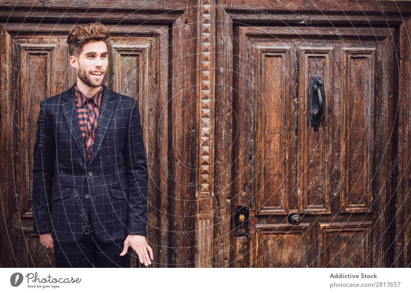 Handsome elegant young fashion man in trendy costume suit, old door wooden background Suit Man Gentleman Fashion fashionable Clothing Style Model Shirt