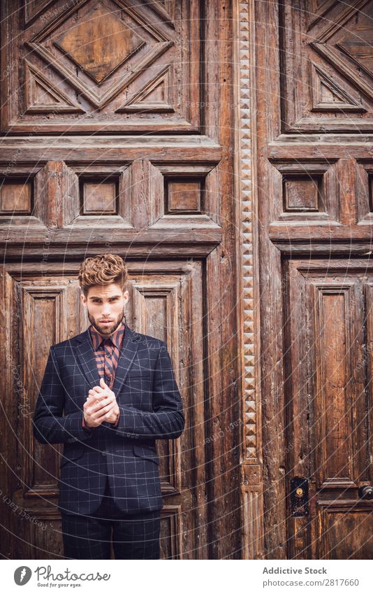 Handsome elegant young fashion man in trendy costume suit, old door wooden background Suit Man Gentleman Fashion fashionable Clothing Style Model Shirt