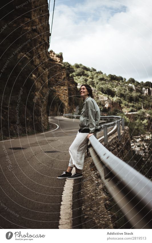 Woman leaning on road fence Roadside Mountain Lean Fence Vacation & Travel Street Summer Girl Youth (Young adults) Human being Adventure Loneliness Nature Trip