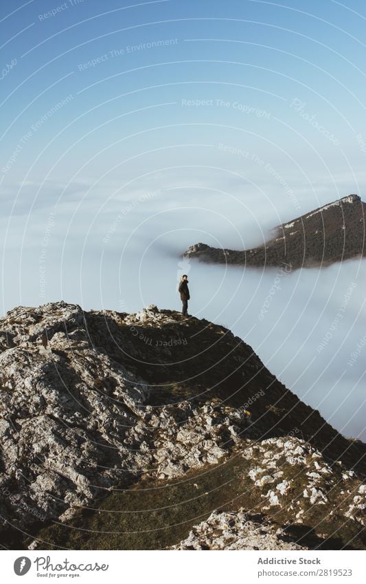 Man on rocky cliff in clouds Edge Mountain Vantage point hiker Height Nature Peak Clouds Action Fat Hiking Stand Cliff Majestic Wanderlust Infinite Landscape