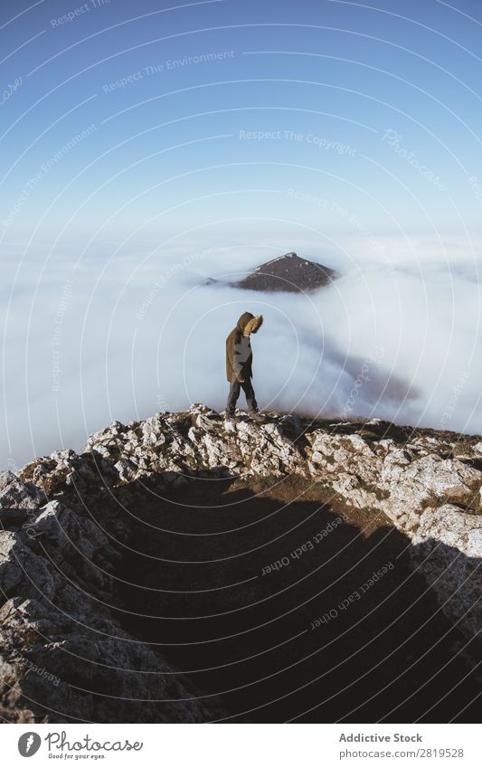 Man on rocky cliff in clouds Edge Mountain Vantage point hiker Height Nature Peak Clouds Action Fat Hiking Stand Cliff Majestic Wanderlust Infinite Landscape