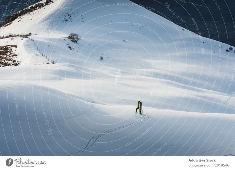 Unrecognizable person skiing in mountains Tourist Skiing Snow Ski resort Winter Vacation & Travel White Nature Alpine Landscape Mountain Extreme Cold Tourism