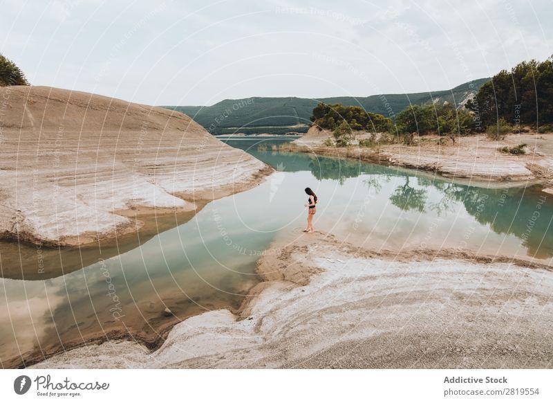 Woman standing at lake shore Coast Lake Stone Mountain Water Landscape Beautiful Beach Nature Vacation & Travel Peaceful Seasons Relaxation Human being Stand