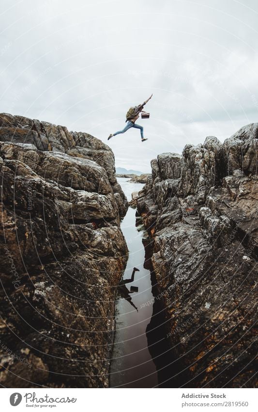 Tourist jumping over gorge Mountain Canyon Jump Vacation & Travel Nature Hiking Landscape Rock Tourism River Adventure Valley Landmark Destination Rural