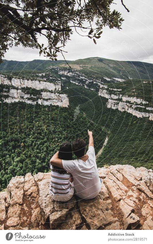 Couple sitting on cliff Cliff Landscape Nature Vacation & Travel Rock Adventure Man Woman Freedom Together Relationship Youth (Young adults) Love Embrace