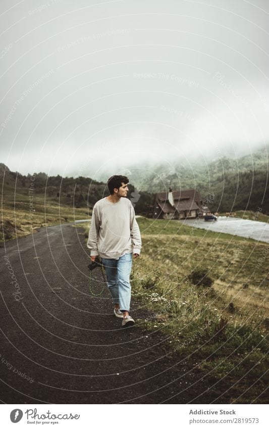 Man with camera walking in countryside Camera Landscape Human being Attractive handsome Leisure and hobbies Trip Tourist Easygoing Nature Youth (Young adults)