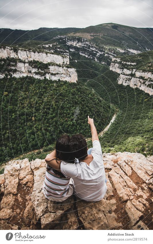 Couple sitting on cliff Cliff Landscape Nature Vacation & Travel Rock Adventure Man Woman Freedom Together Relationship Youth (Young adults) Love Embrace