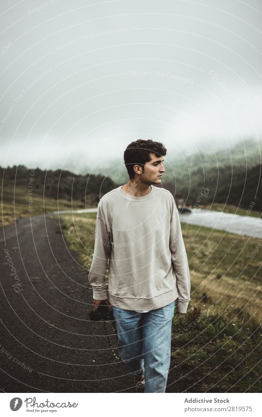 Man with camera walking in countryside Camera Landscape Human being Attractive handsome Leisure and hobbies Trip Tourist Easygoing Nature Youth (Young adults)