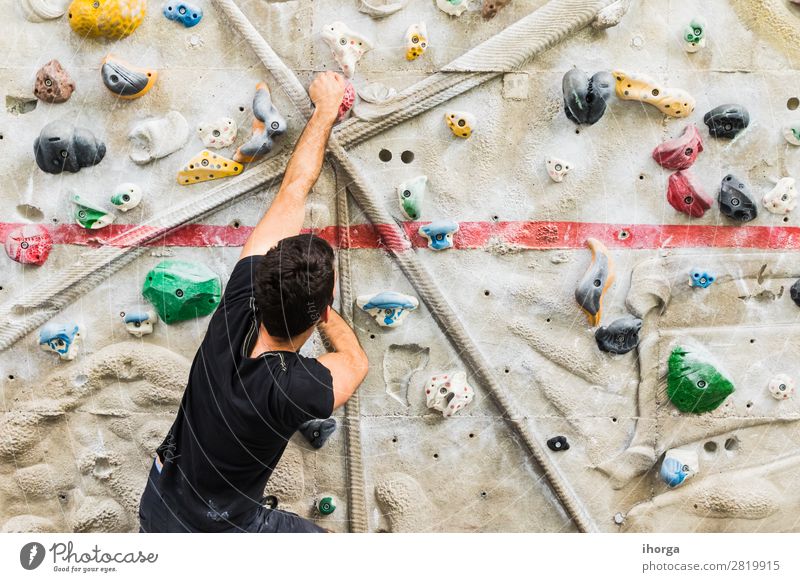 Man practicing rock climbing on artificial wall indoors. Lifestyle Joy Leisure and hobbies Sports Climbing Mountaineering Human being Masculine Adults 1