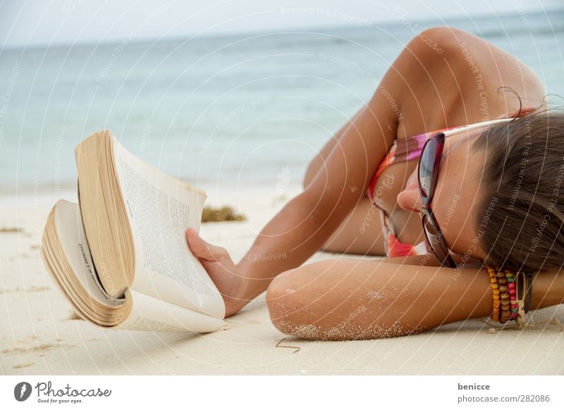 beach read Woman Human being Tourist Book Reading Eyeglasses Beach Lie Education Print media Summer Tourism Relaxation Calm Ocean Water 1 Person Brunette