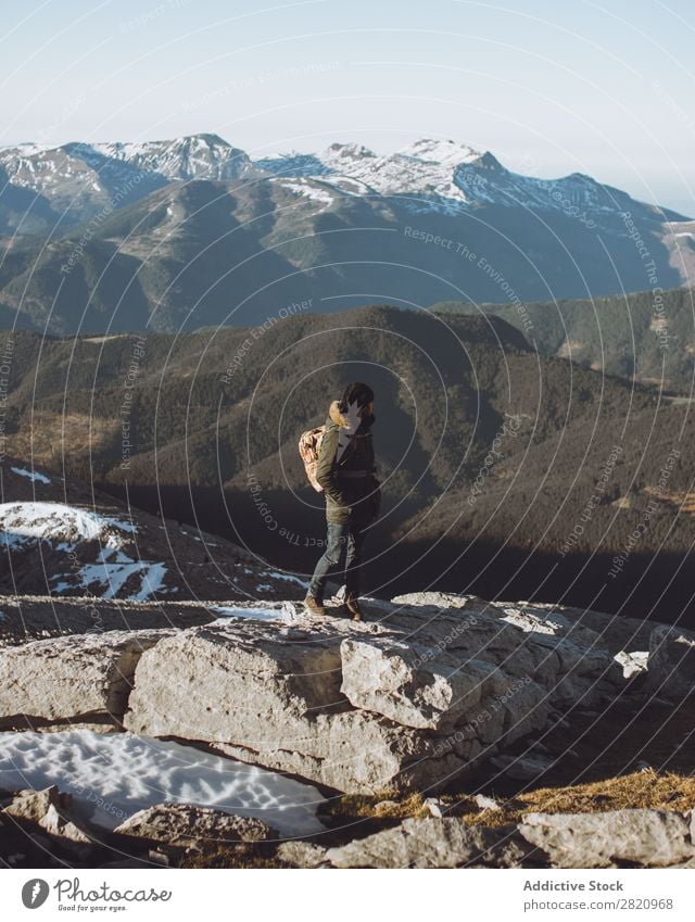 Man in outerwear on snowy mountains Mountain Snow hiker Action motivation Tourist Sunlight Stand Portrait photograph Tourism Weather Cold Extreme